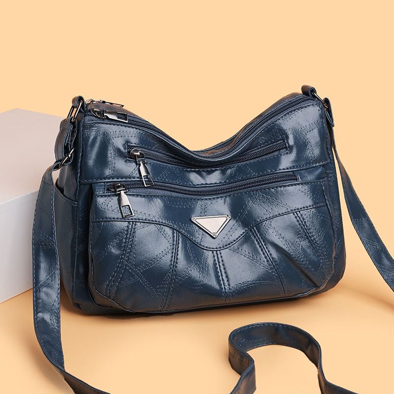Bolso bandolera con textura de piel