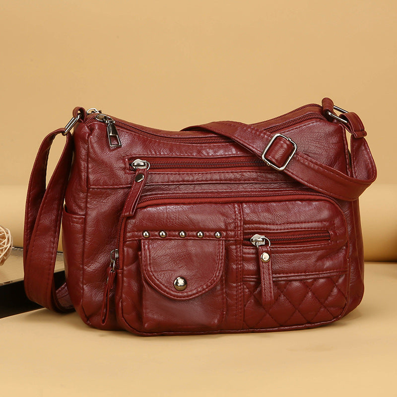 Bolso bandolera multicompartimentos de piel suave