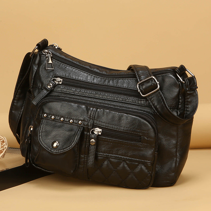 Bolso bandolera multicompartimentos de piel suave