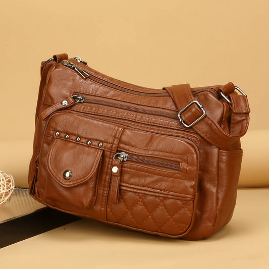 Bolso bandolera multicompartimentos de piel suave