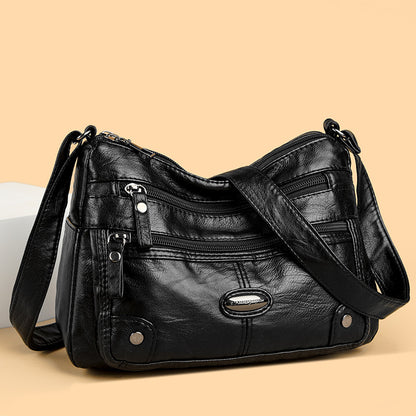 Bolso de piel con etiqueta de hierro ovalada